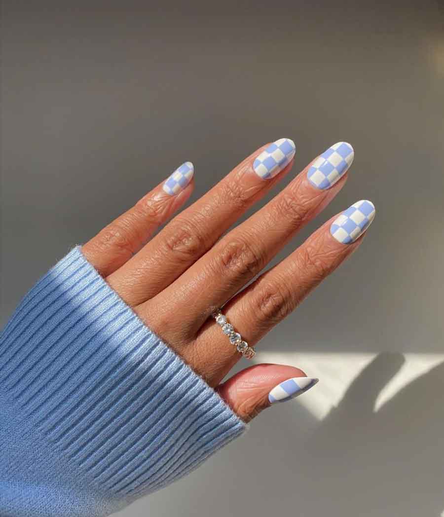 A woman's hand with blue and white nails - Nails