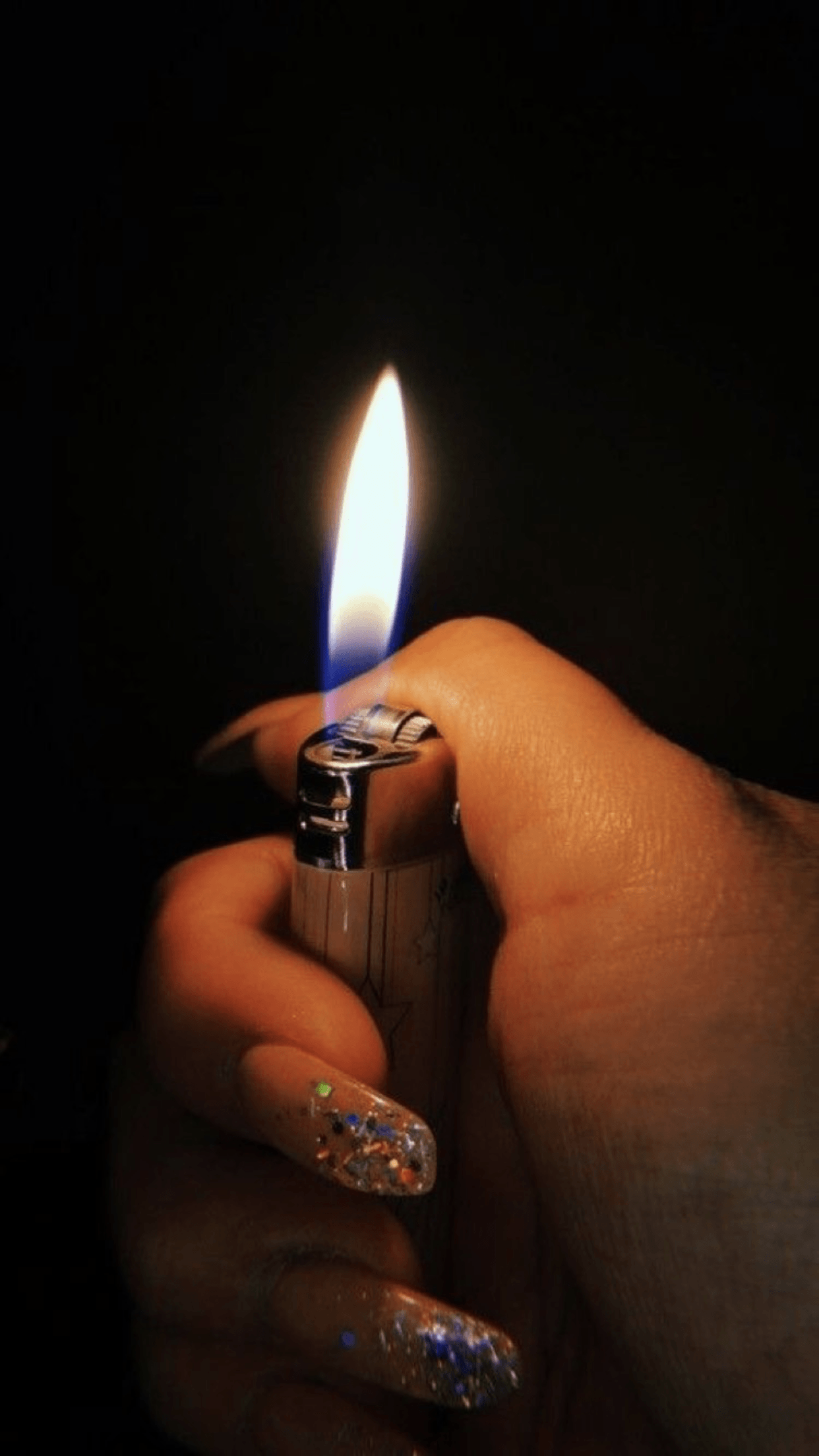 A person holding up an open lighter - Nails