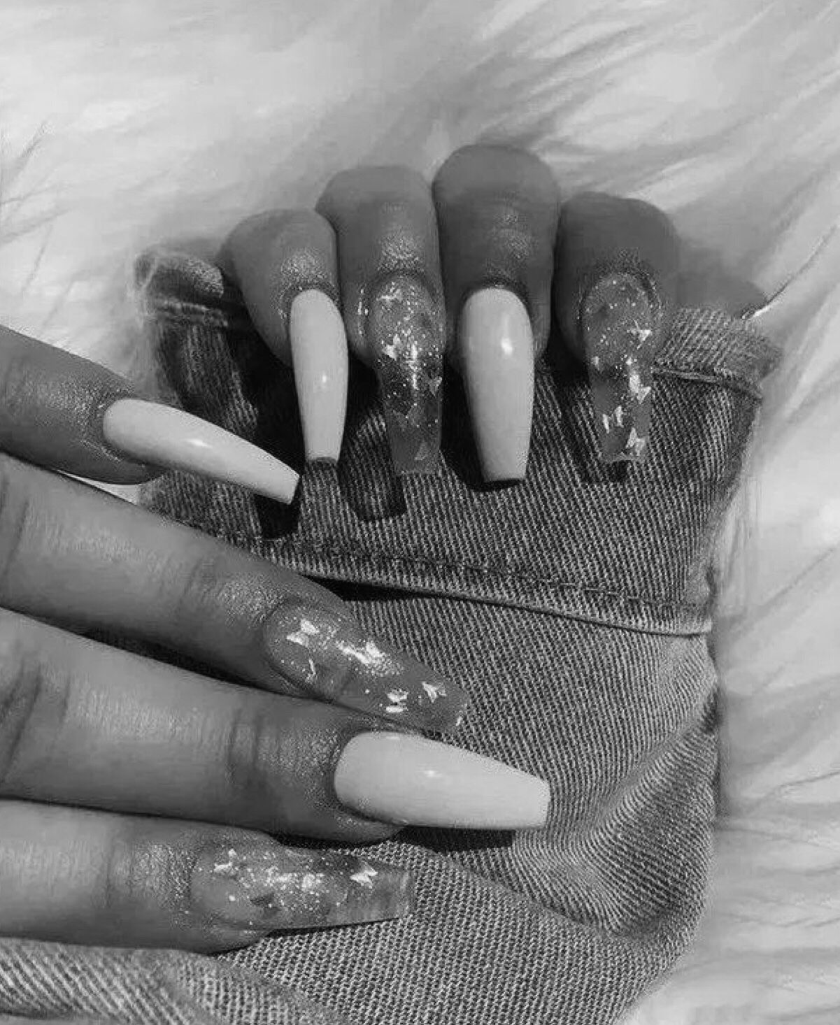 A woman with long nails and white acrylics - Nails