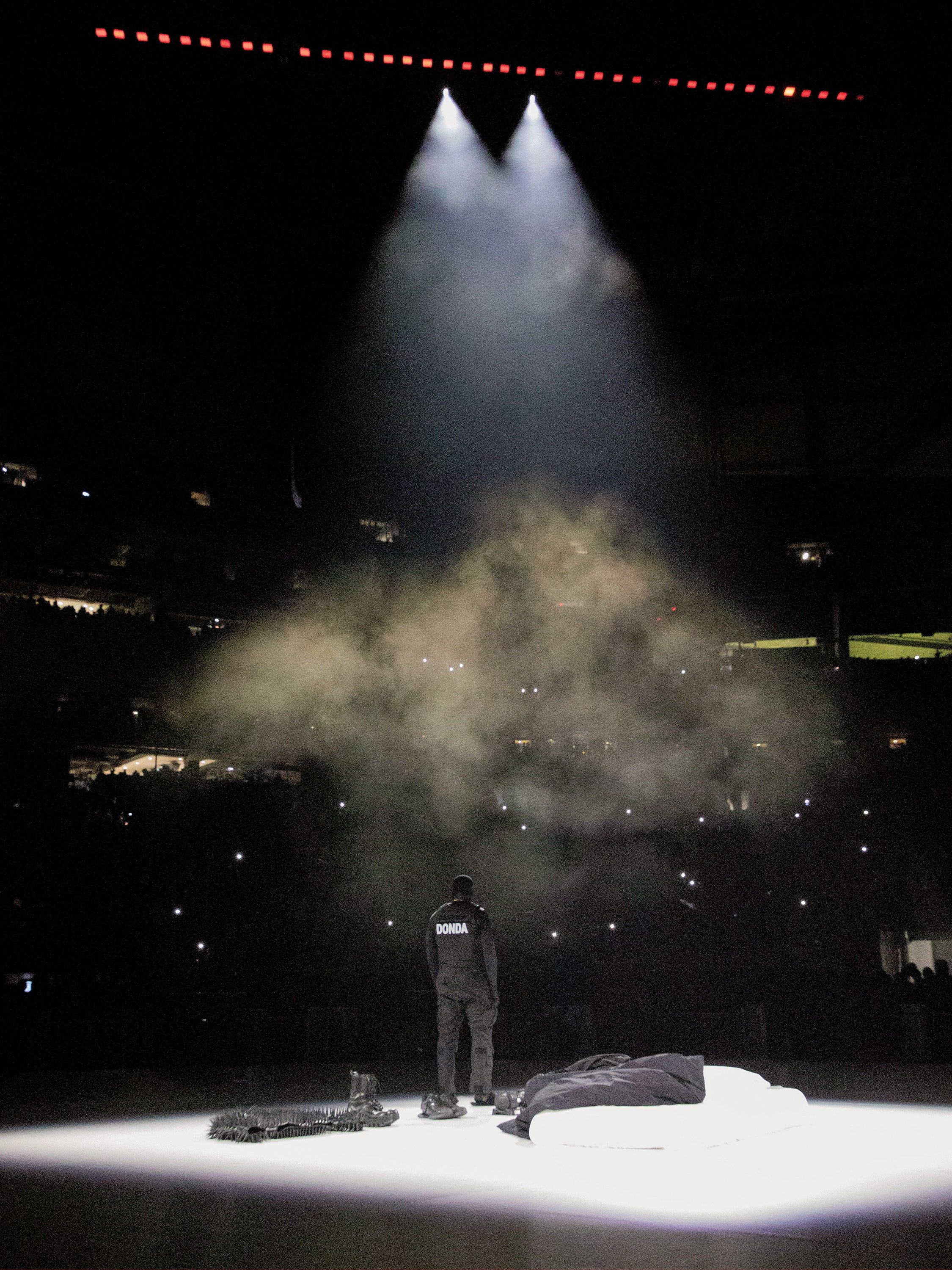 A man standing on the ice with smoke in front of him - Kanye West