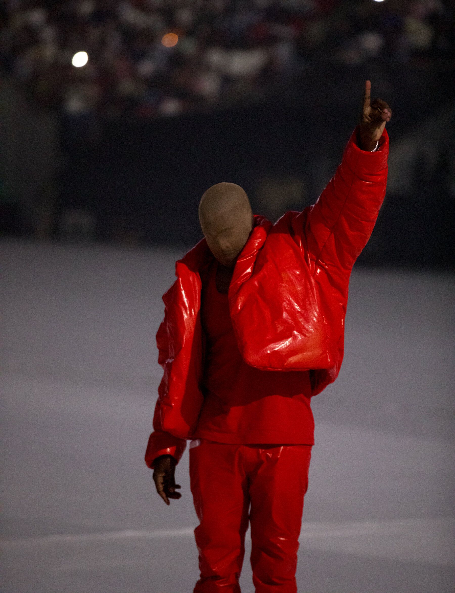 A man in red is standing on top of the snow - Kanye West