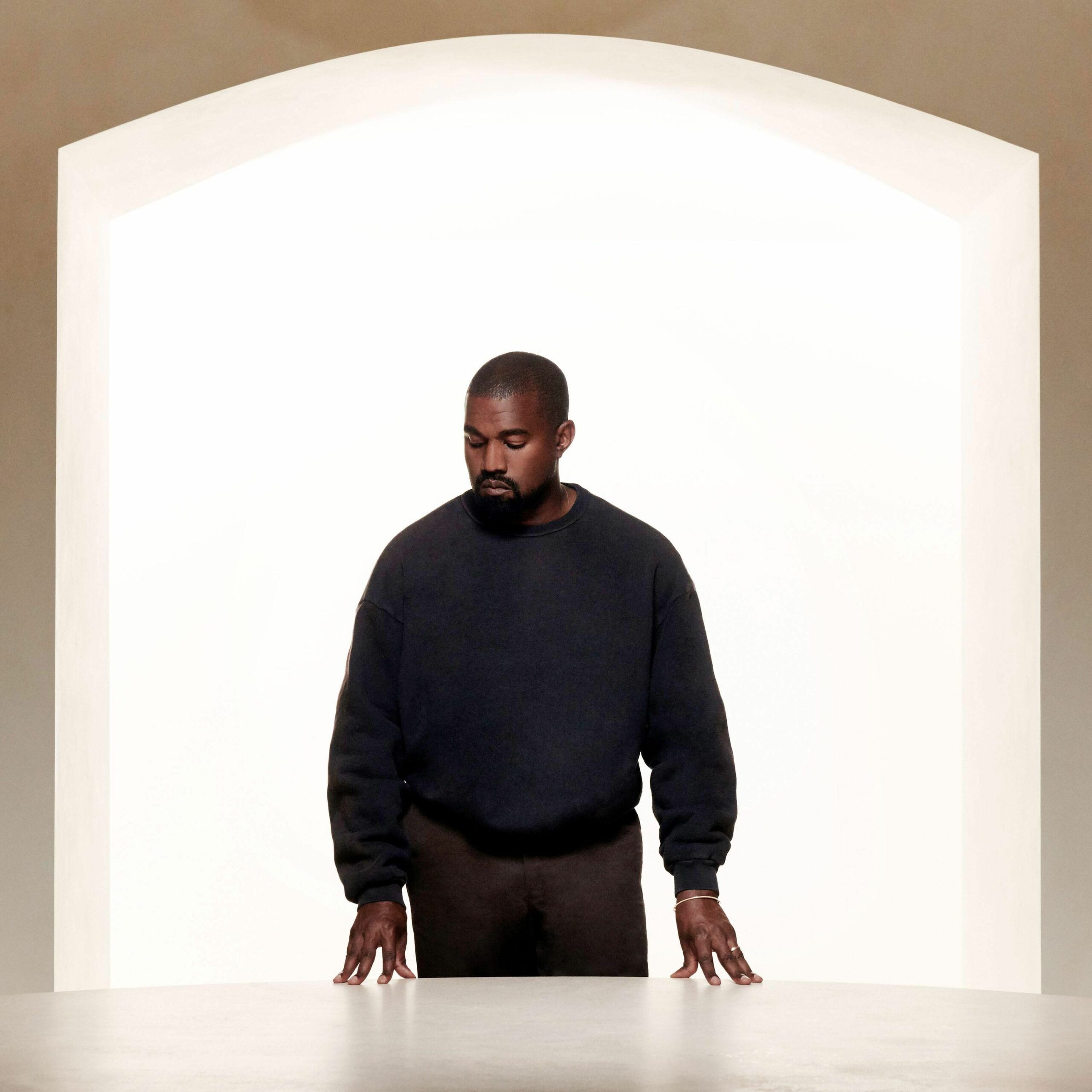 A man standing in front of an archway - Kanye West