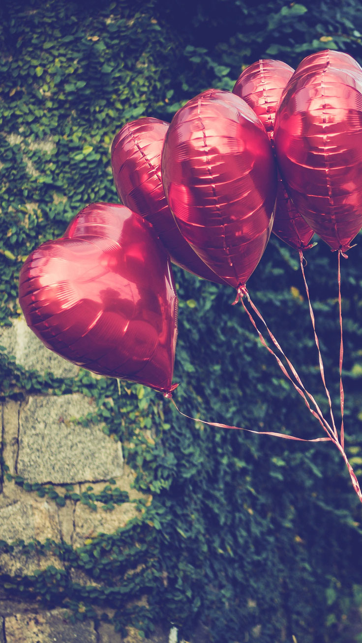 A group of red balloons in the air - Valentine's Day