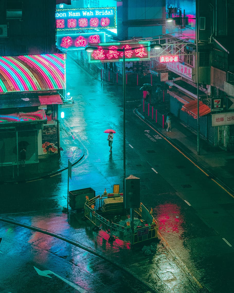A man with an umbrella walks down a street at night. - Aqua, rain
