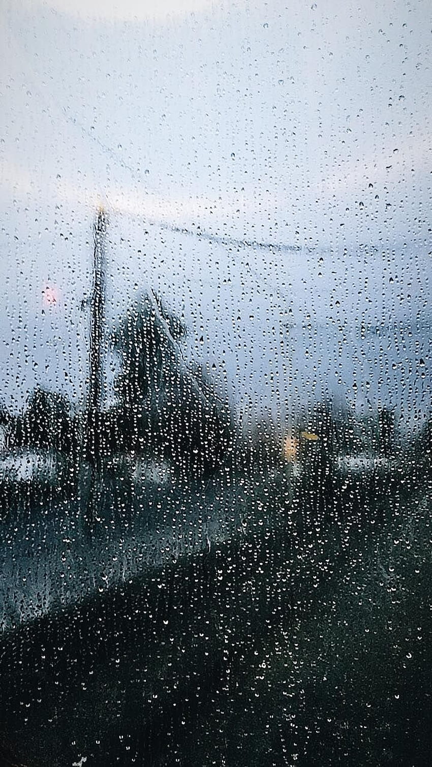 Raindrops on a window with a view of a street - Rain