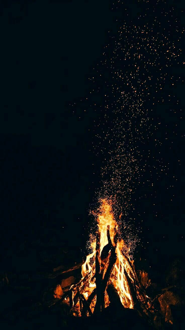 A bonfire at night with sparks flying - Fire, flames