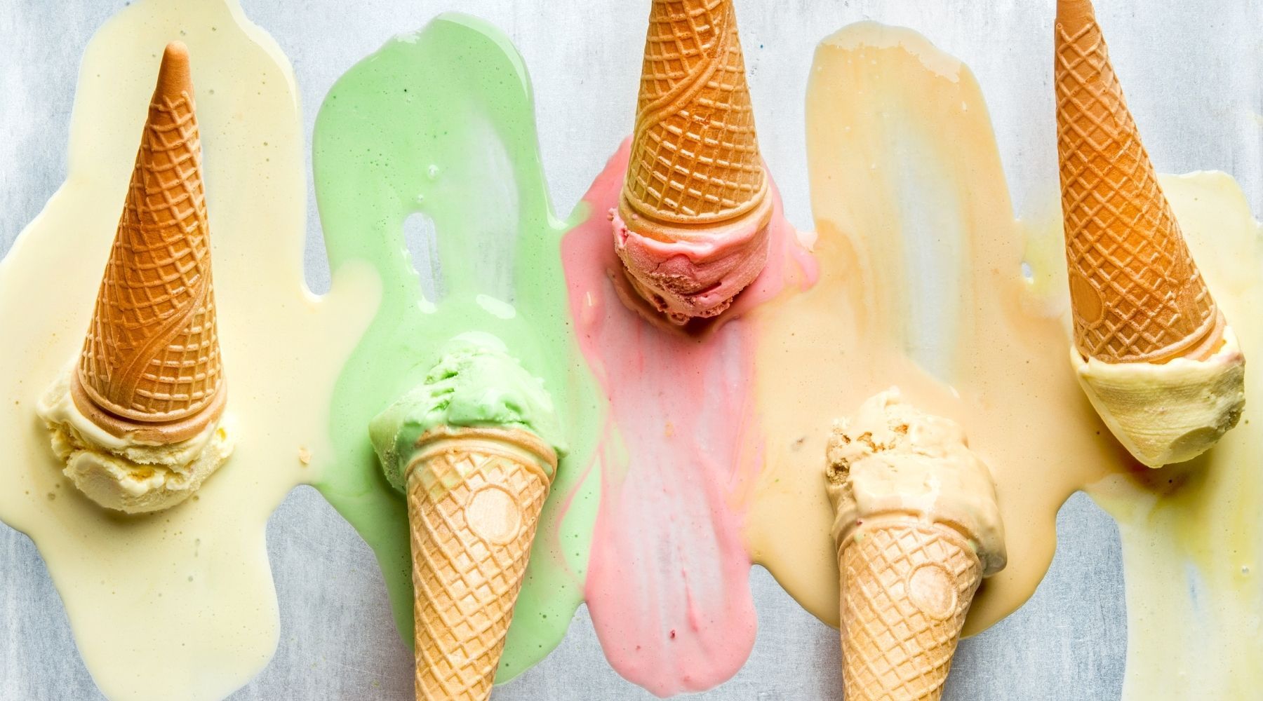 Four cones of melting ice cream in different colors on a white background - Ice cream