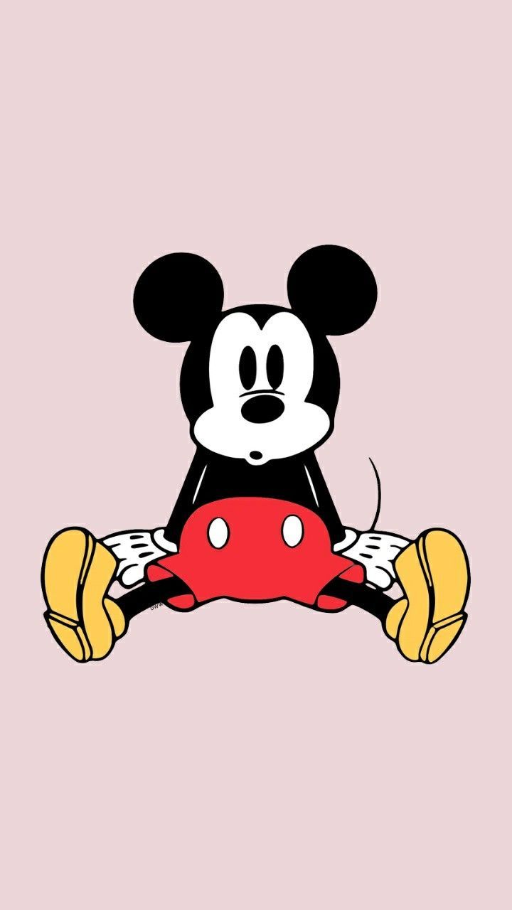 The mickey mouse cartoon character is sitting on a pink background - Mickey Mouse