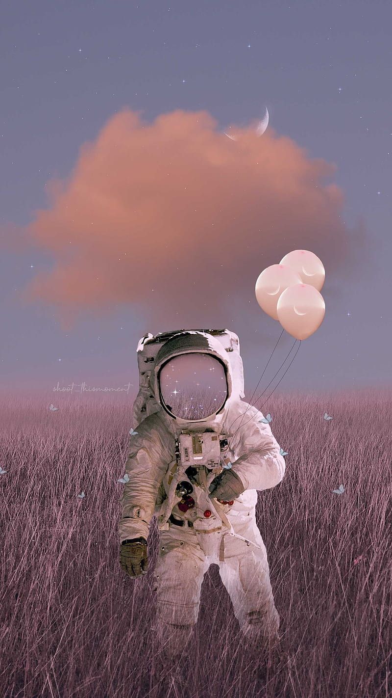 A man in an astronaut suit holding balloons - Astronaut, balloons