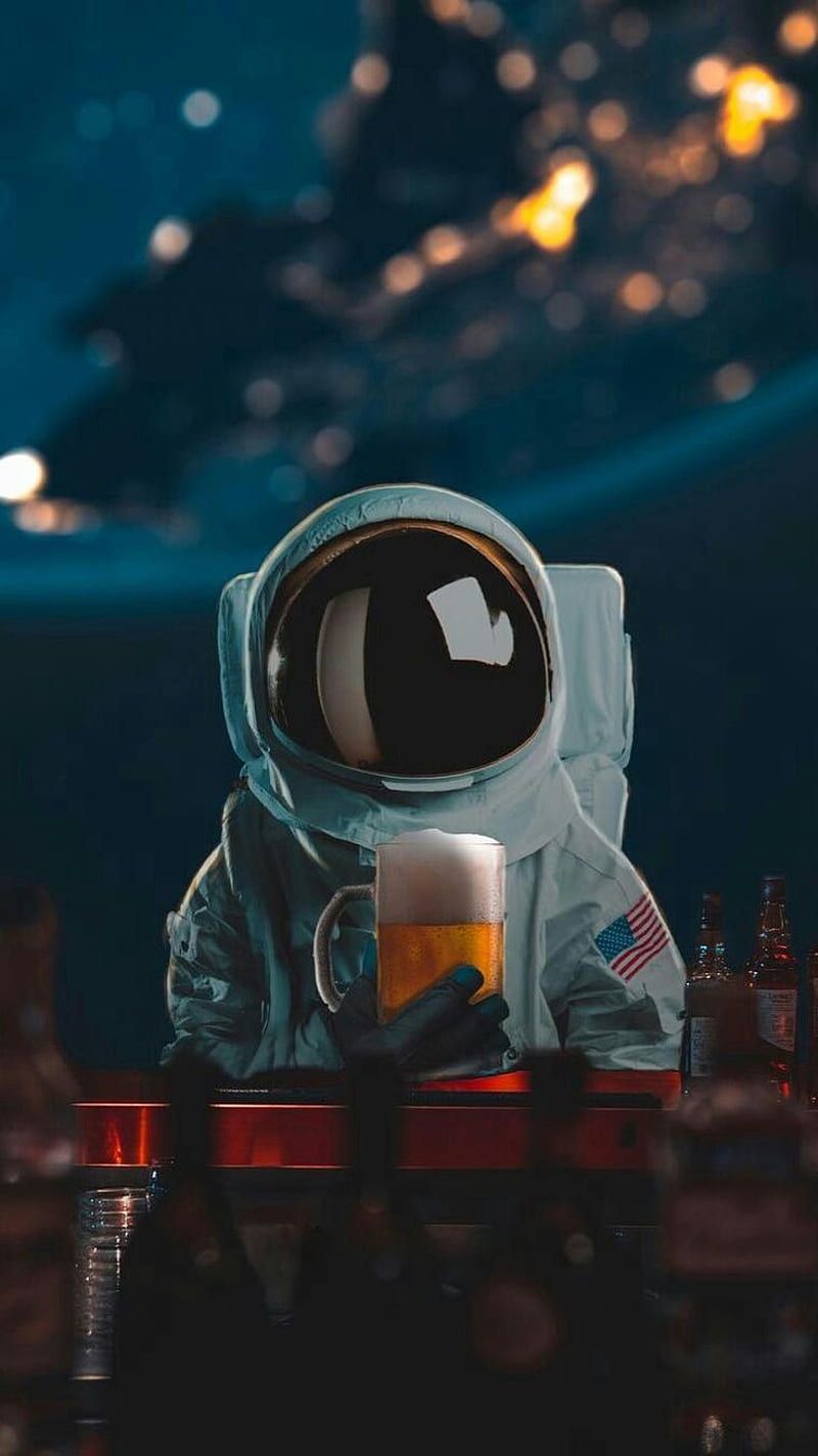 An astronaut drinking beer in space - Astronaut