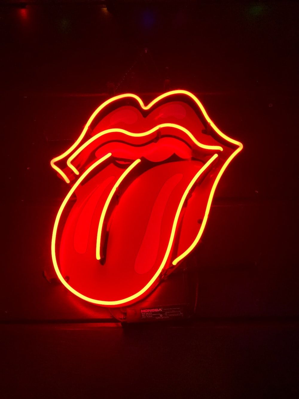 A red neon sign of the rolling stones logo - Light red, neon red