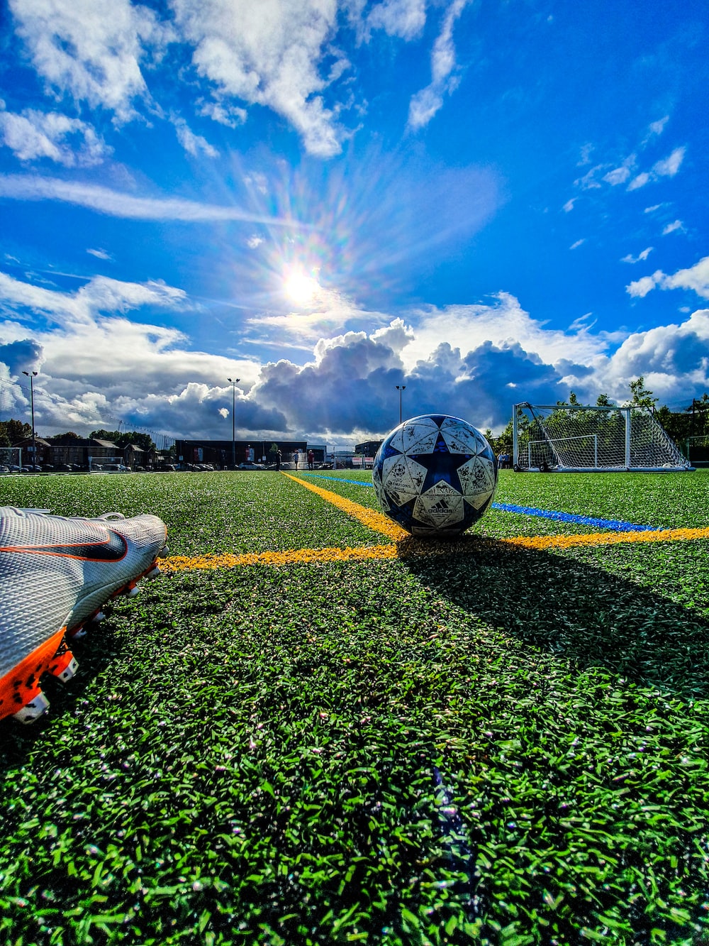 A soccer ball and shoe on the field - Soccer