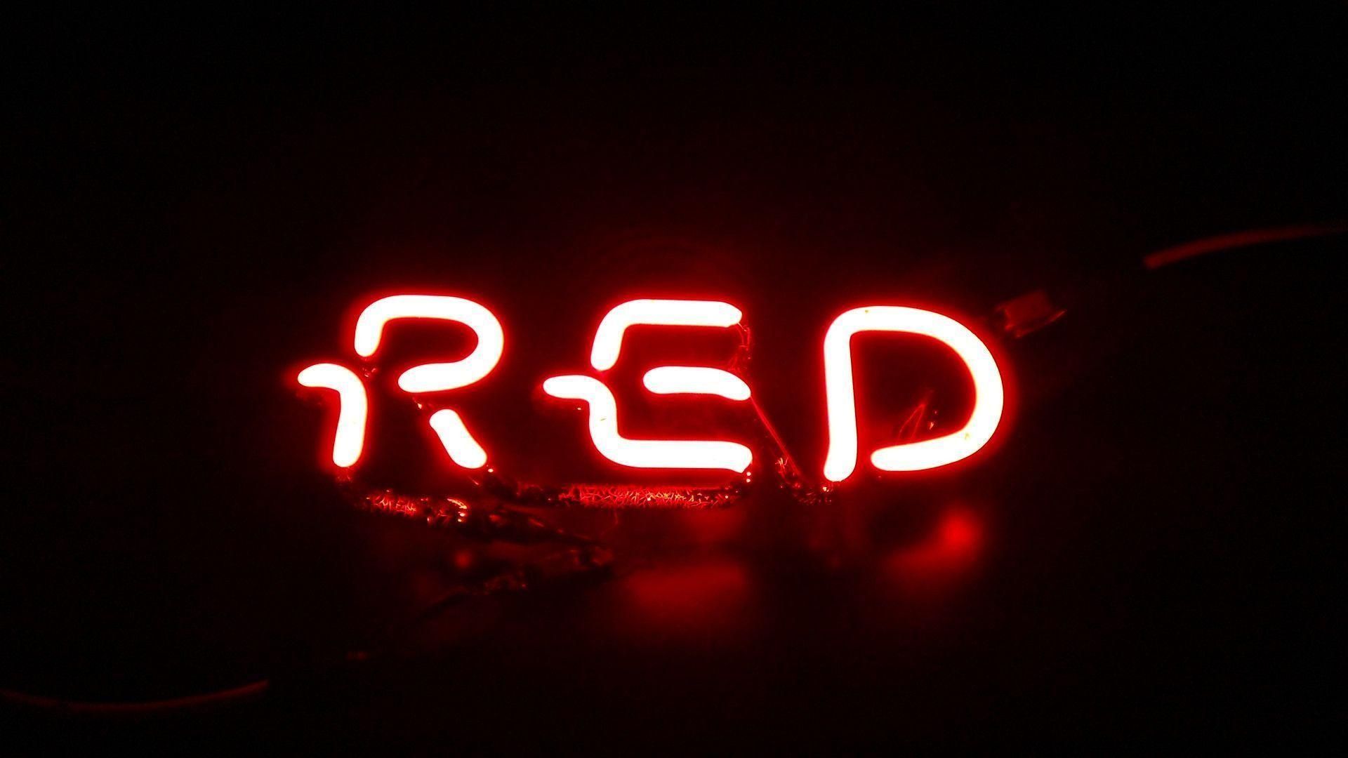 A red neon sign that is lit up - 