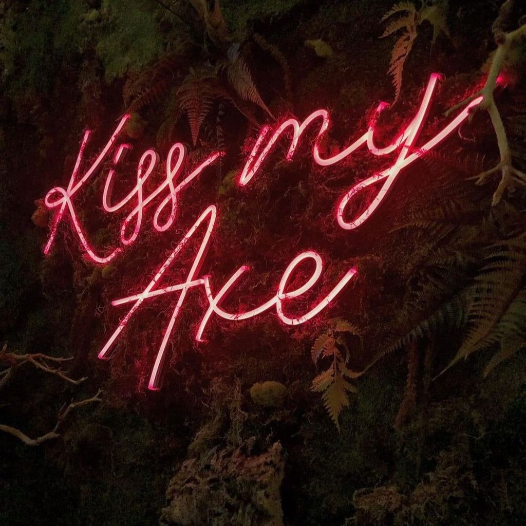 A neon sign that says kiss my axe - 