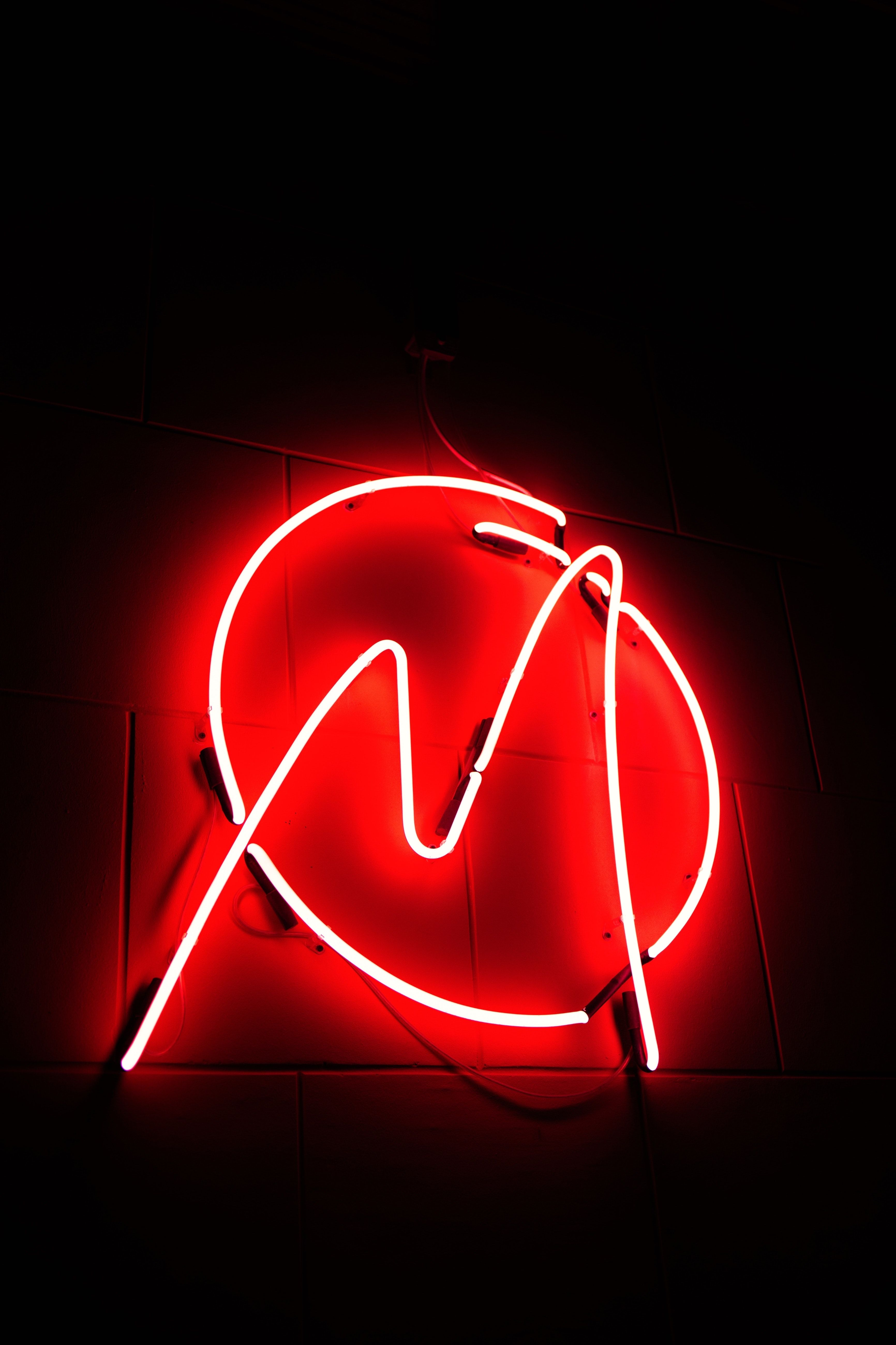 A red neon sign with the letter N on it - Neon red