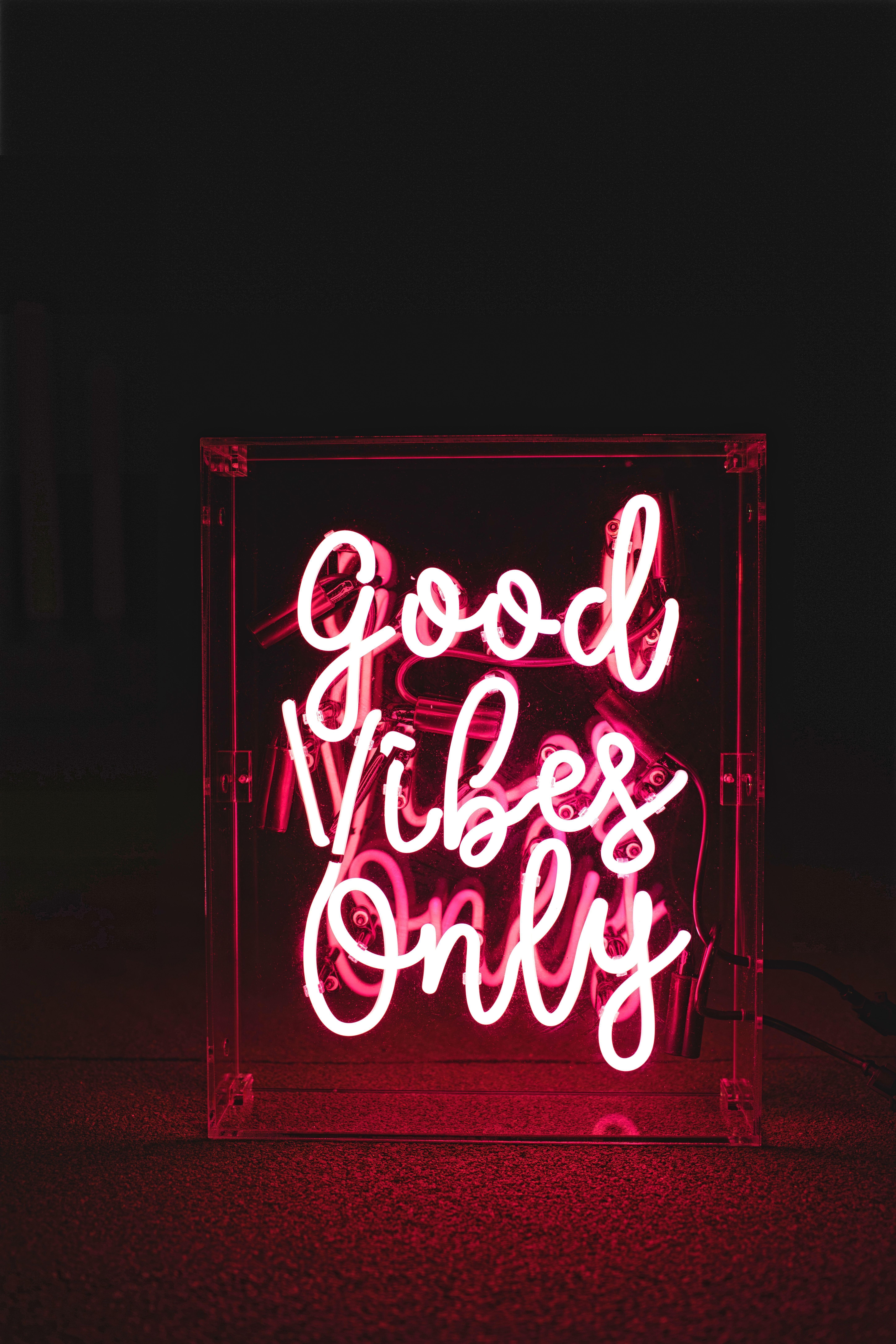 A neon sign that says good vibes only - Neon red
