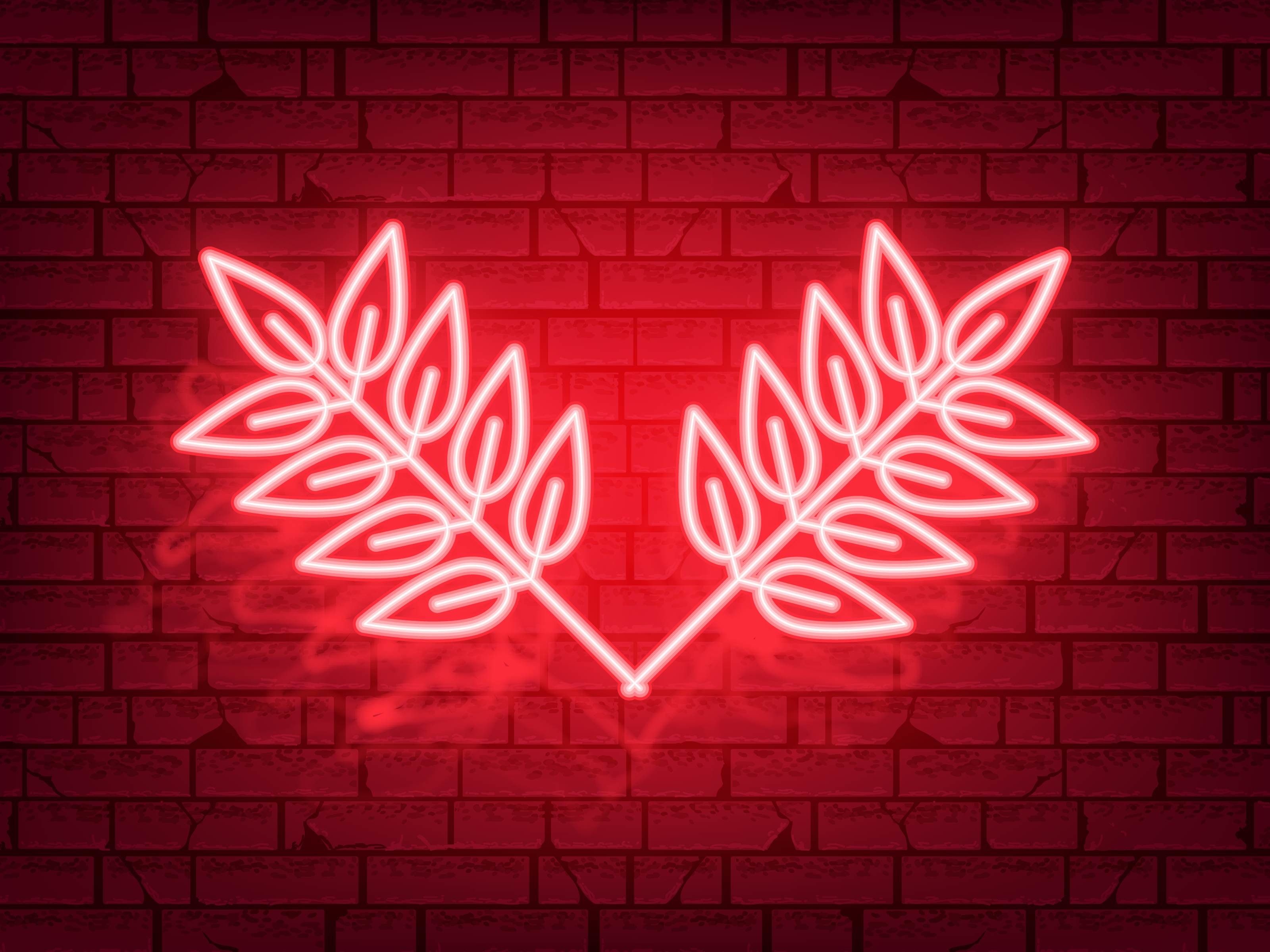 A neon sign of a heart made out of leaves - 