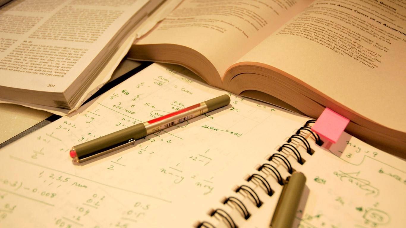 Books, pens and notes on a desk - Study