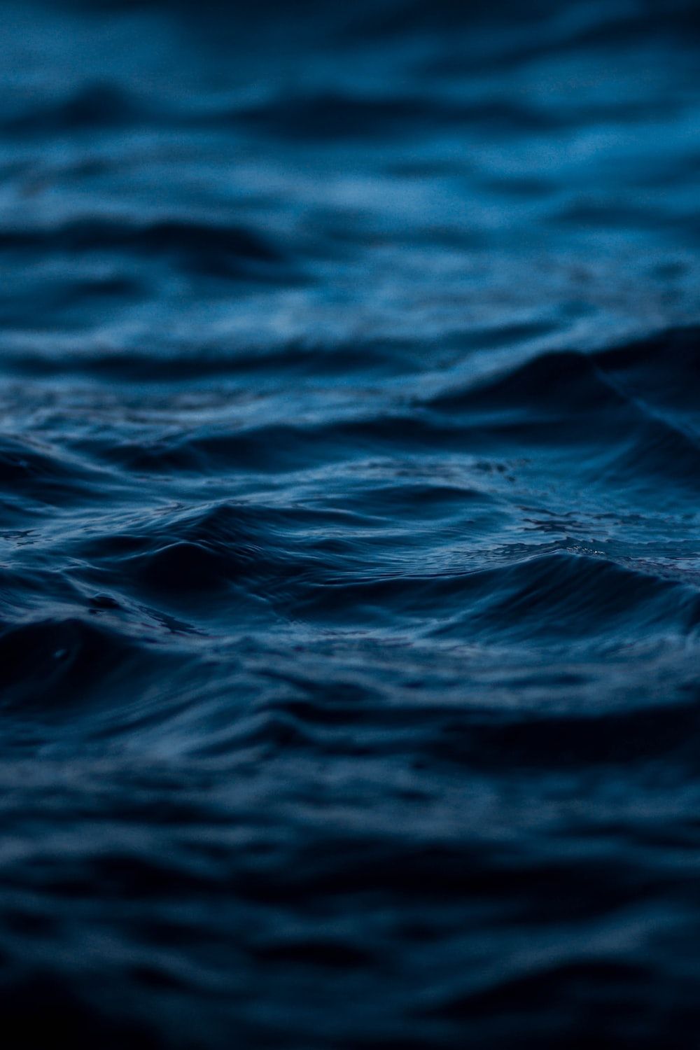 A close up of the ocean with a blue hue - Water