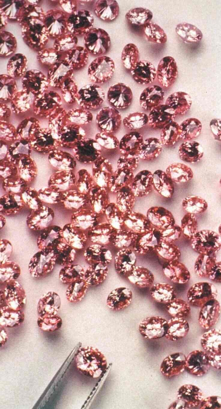 A pile of pink diamonds on a white table. - Diamond