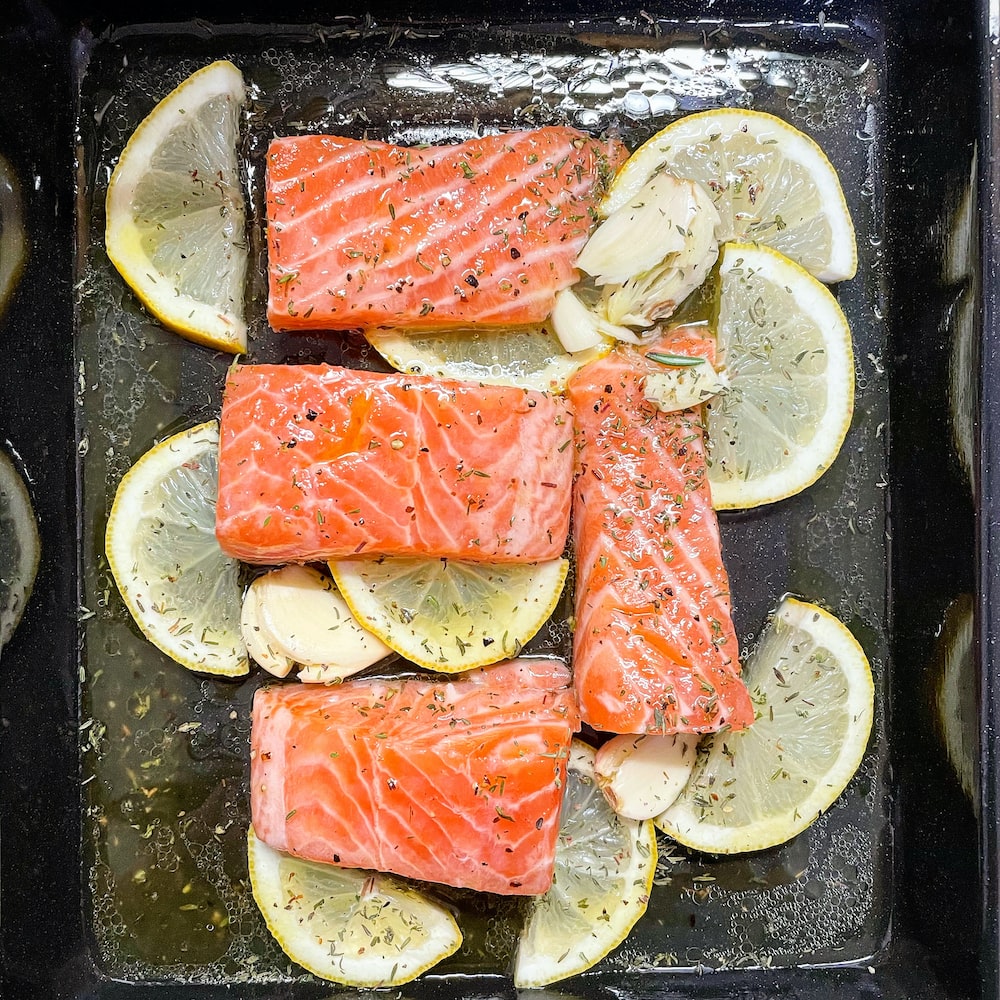 Salmon with lemon slices on a baking tray - Salmon