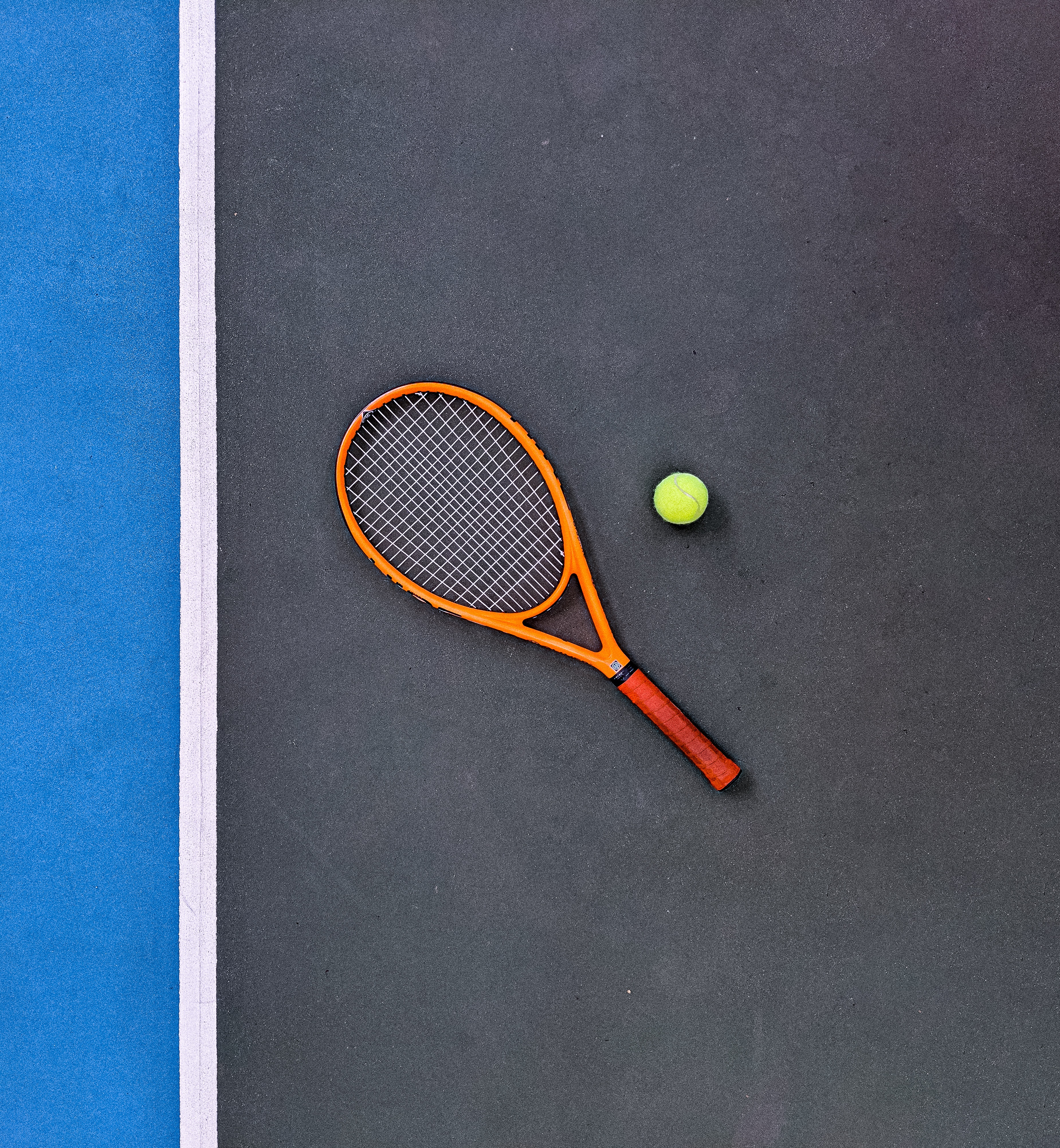 A tennis racket and ball on a tennis court - Tennis