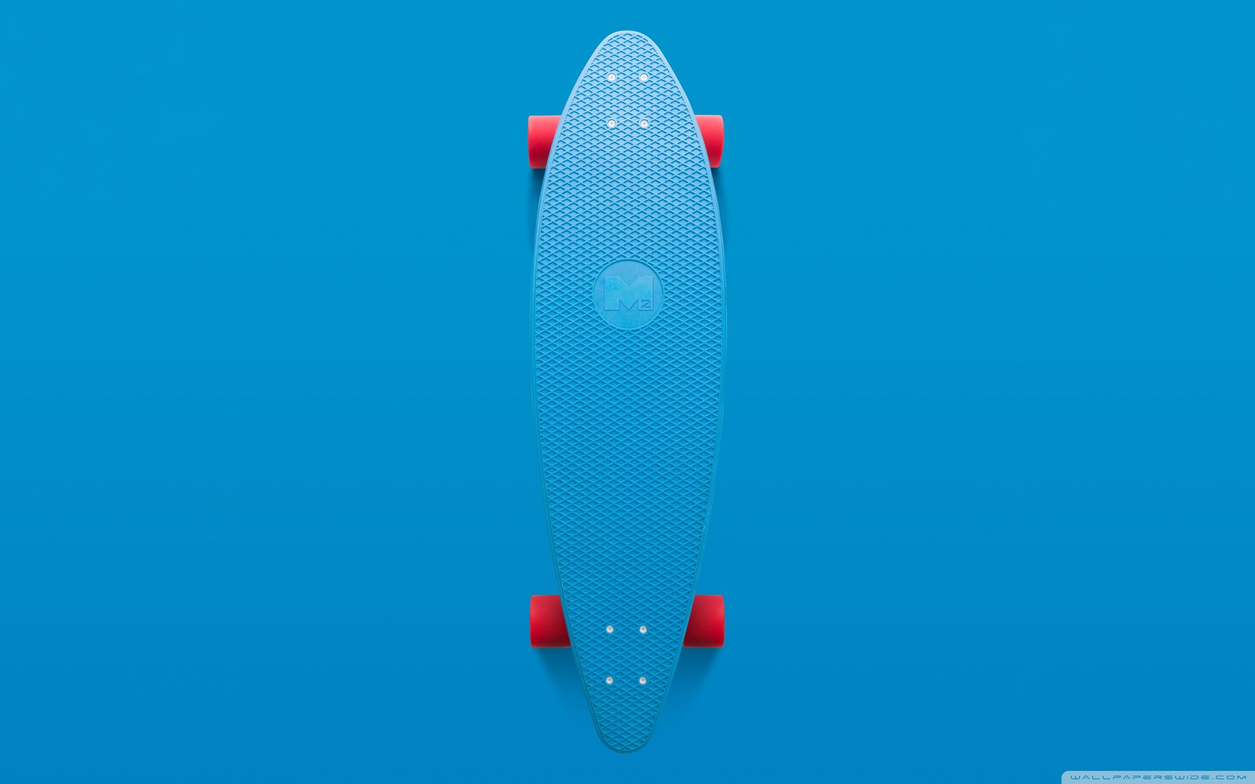 A blue skateboard on top of some red wheels - 2560x1600