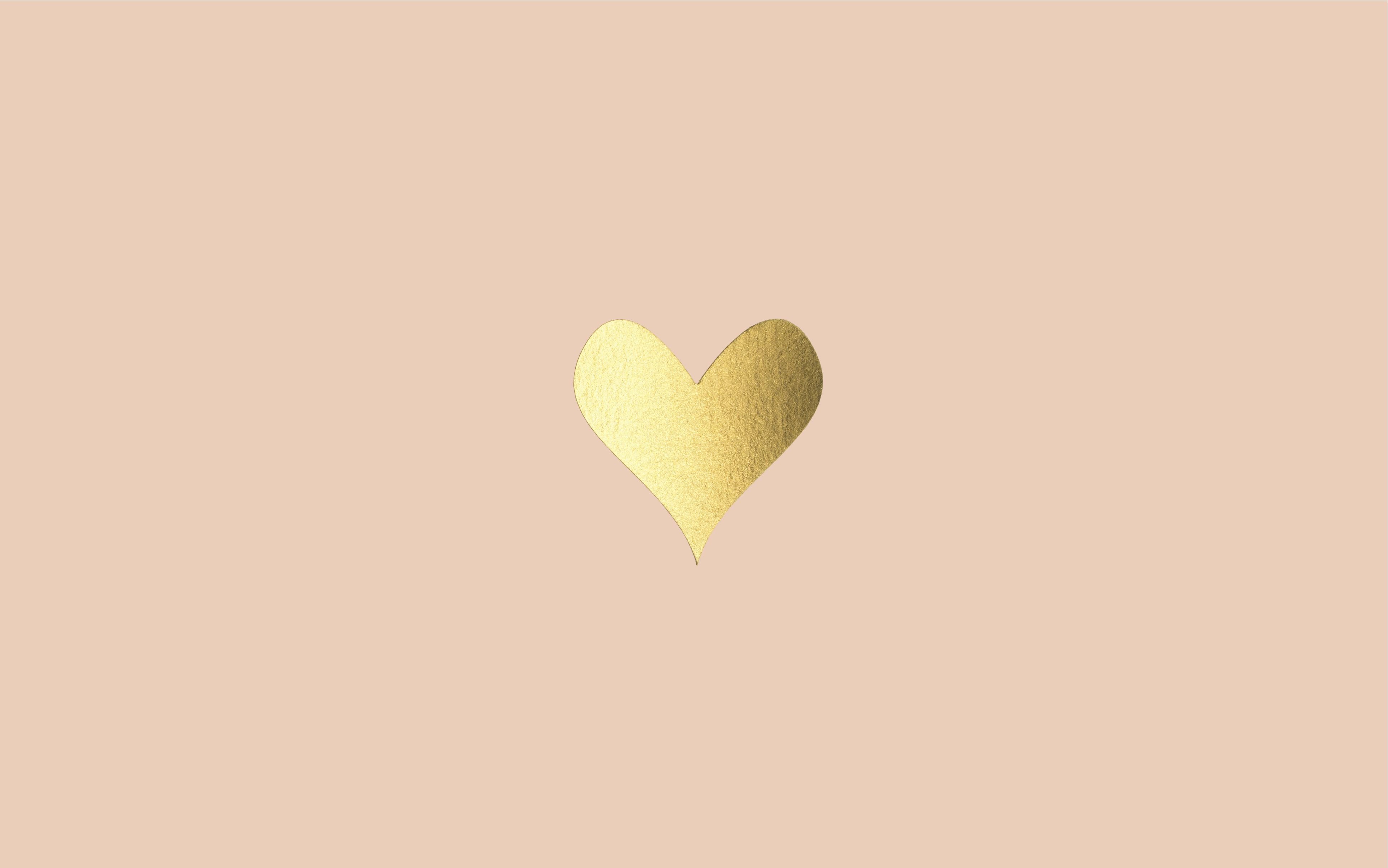 A gold heart on a pink background - Minimalist beige