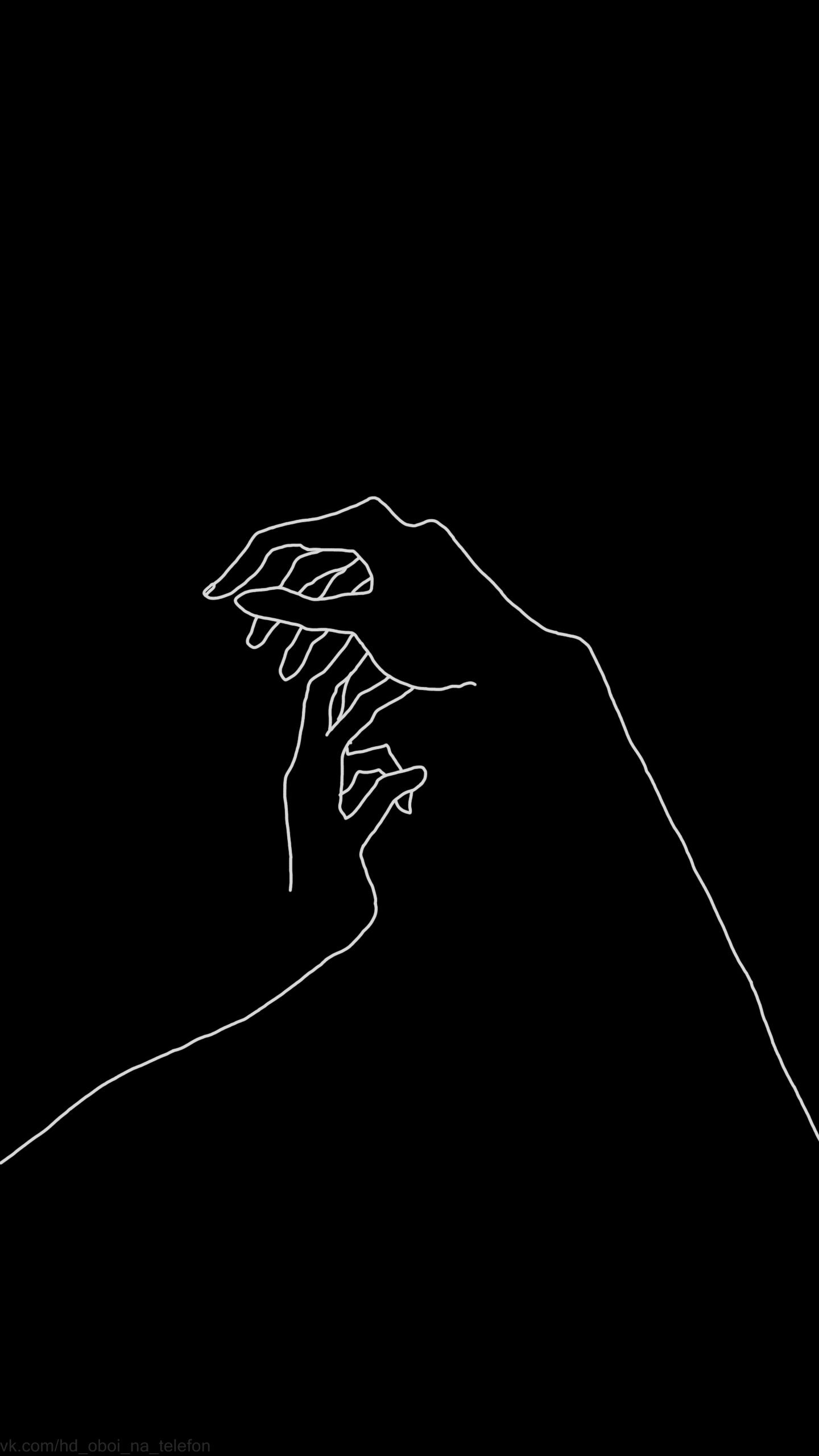 A hand holding another one in the dark - Black and white