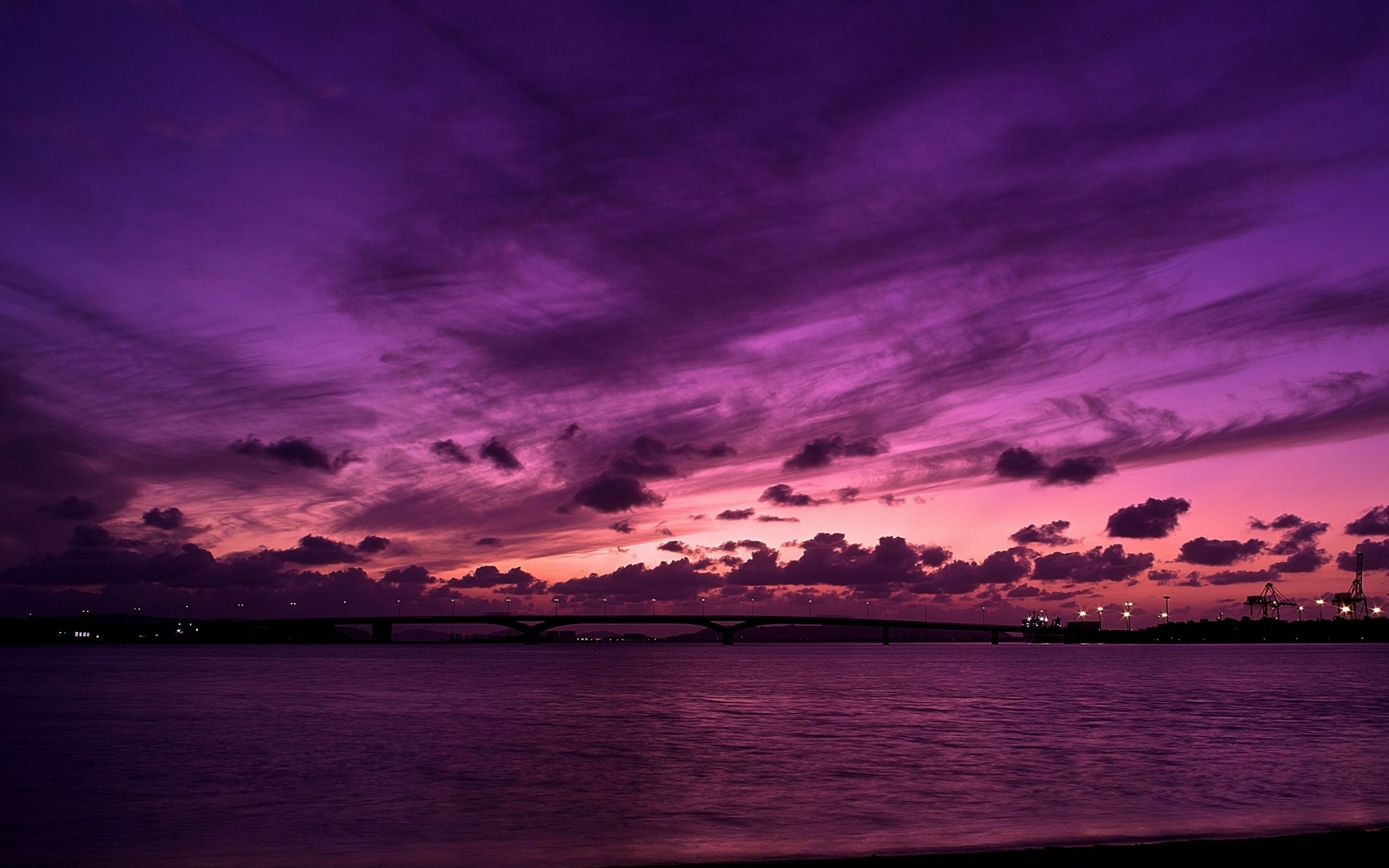 A purple sky with clouds over the water - 2560x1600
