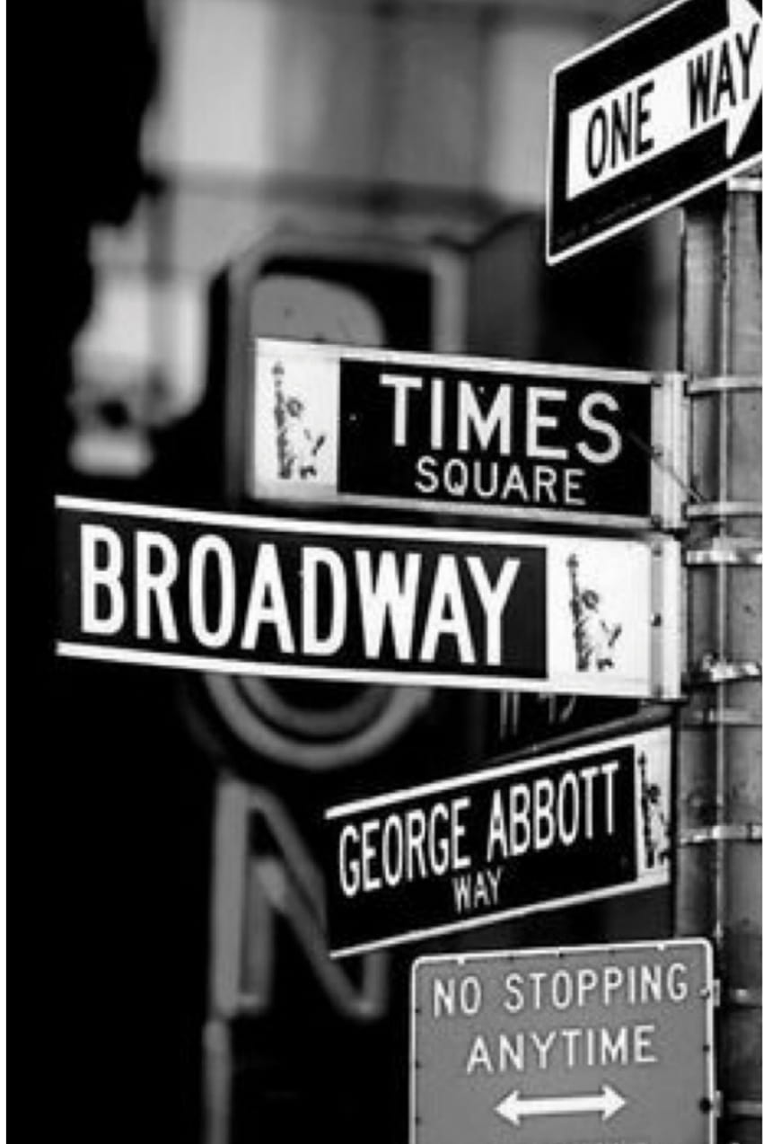 A black and white photo of street signs in New York City. - Broadway