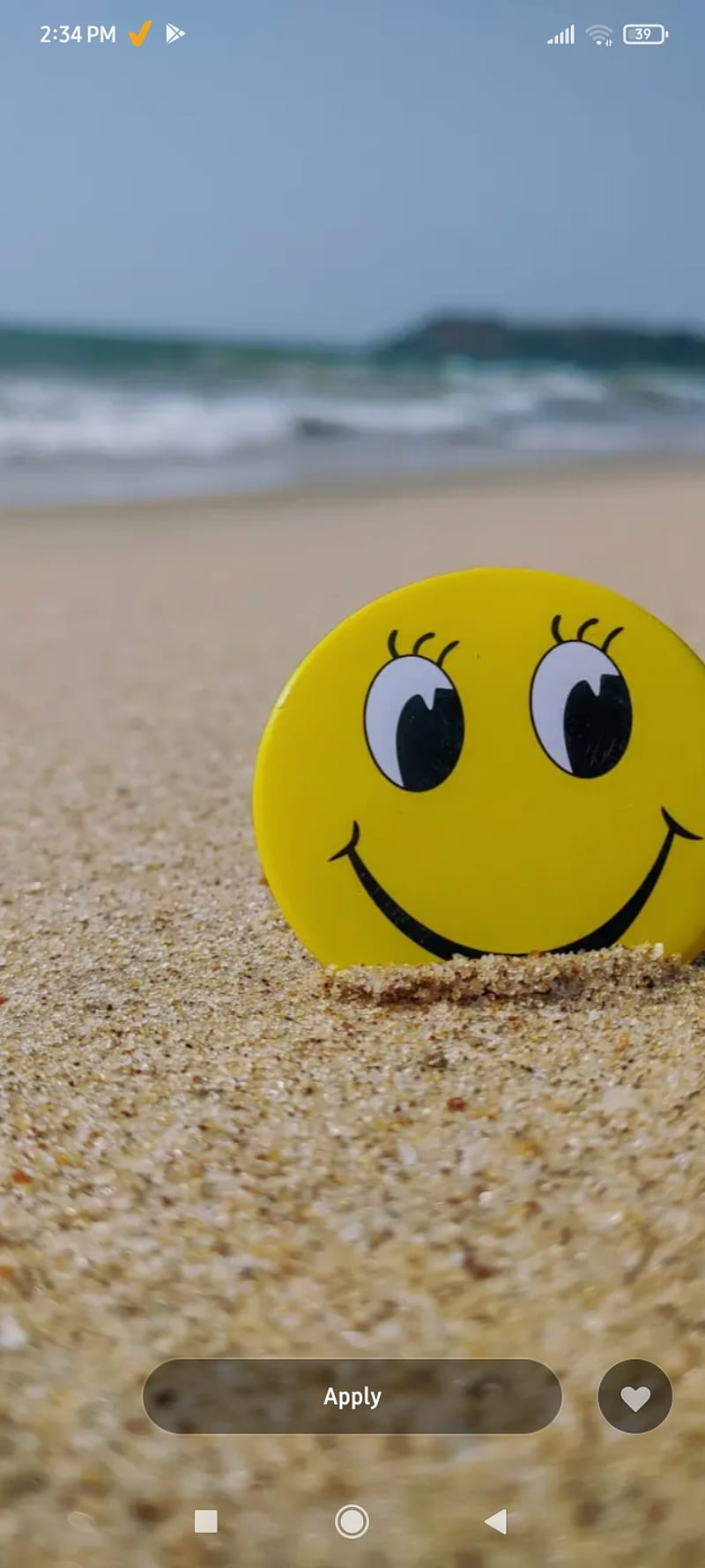 A smiling emoji on the beach - Emoji