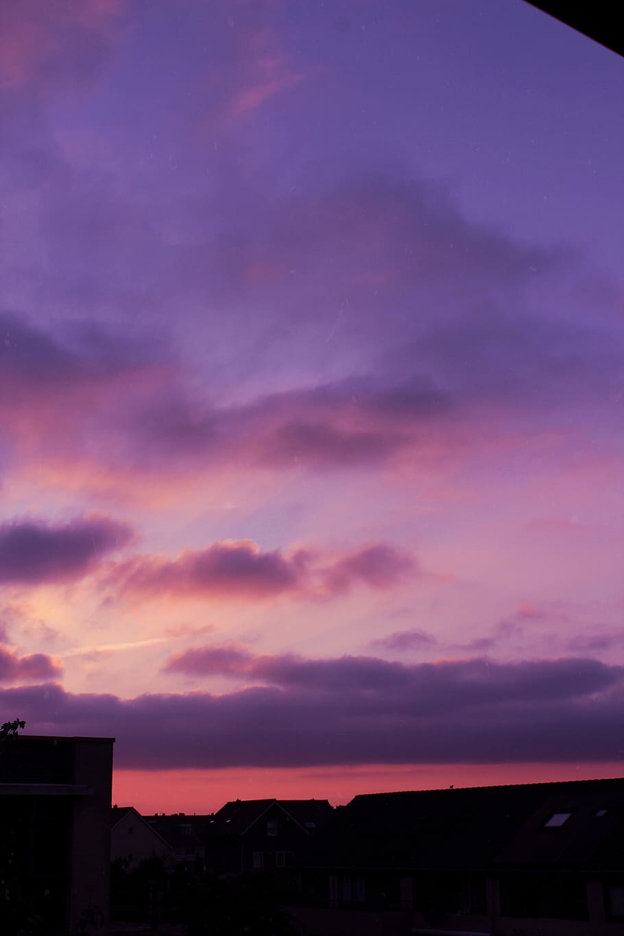 A sky with clouds and the sun setting - Pastel purple