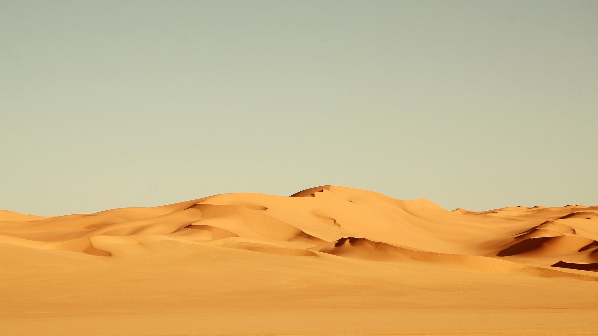 A man riding on top of his horse in the desert - Desert