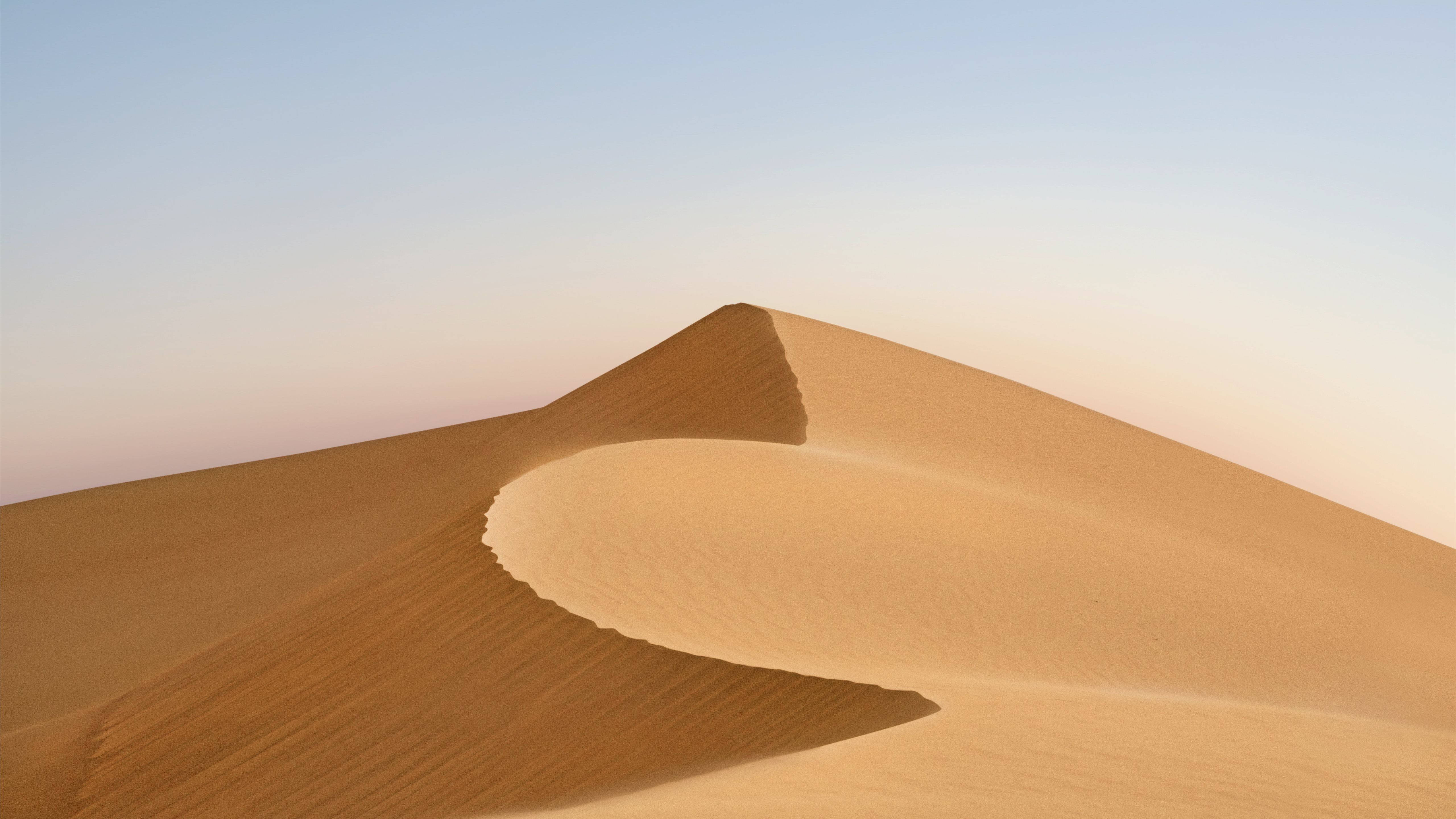 A person is riding on top of the sand - Desert