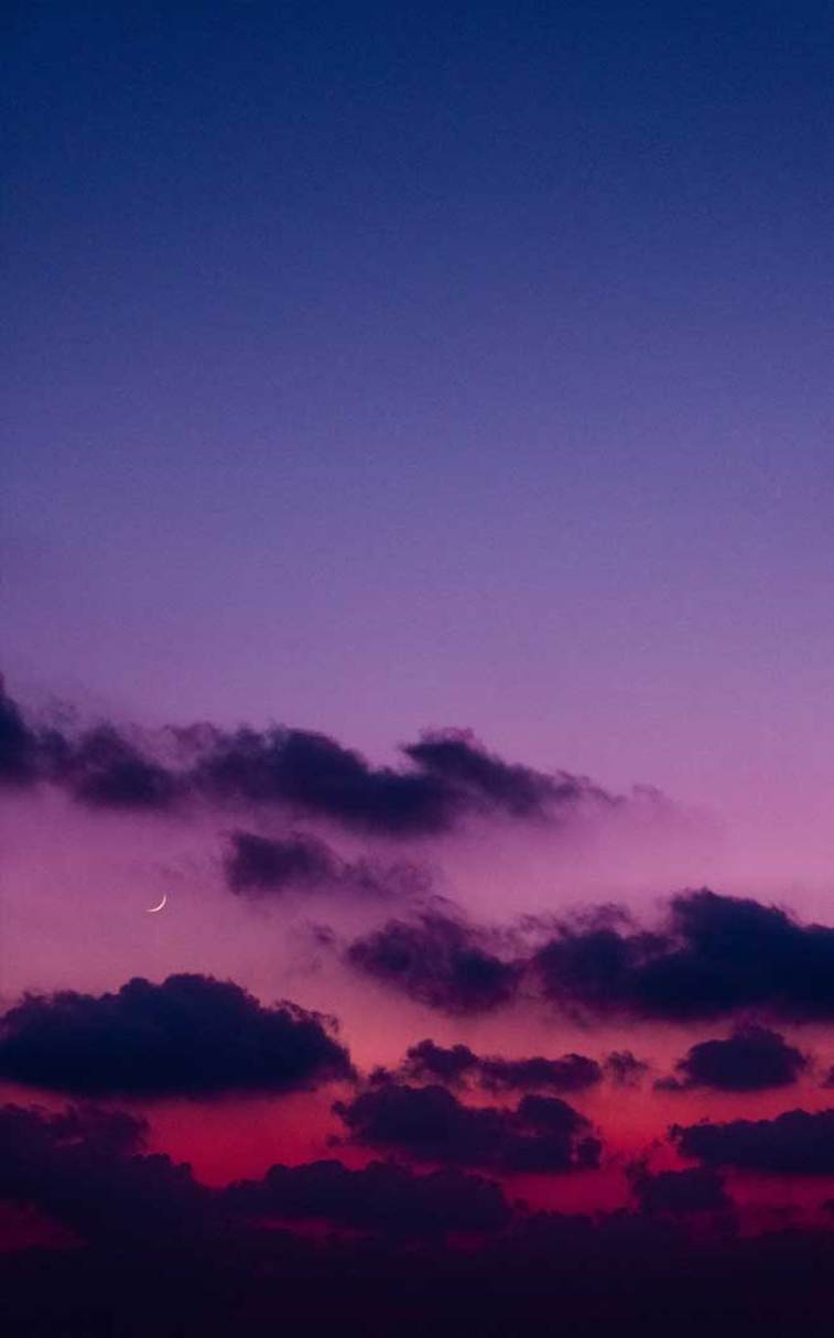 A beautiful sunset with clouds and the moon in it - Indigo