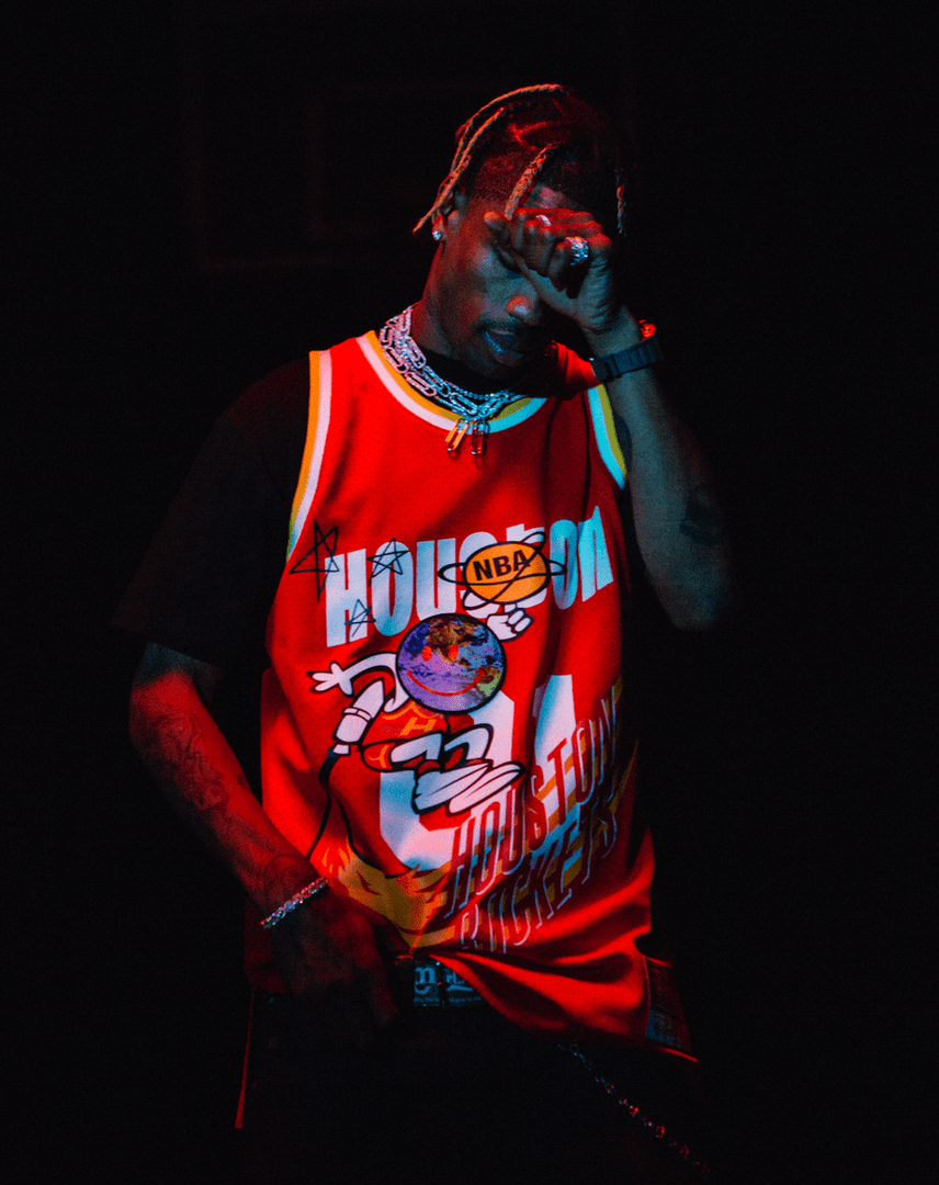 Travis Scott in a Houston Rockets jersey with his hand on his face - Travis Scott
