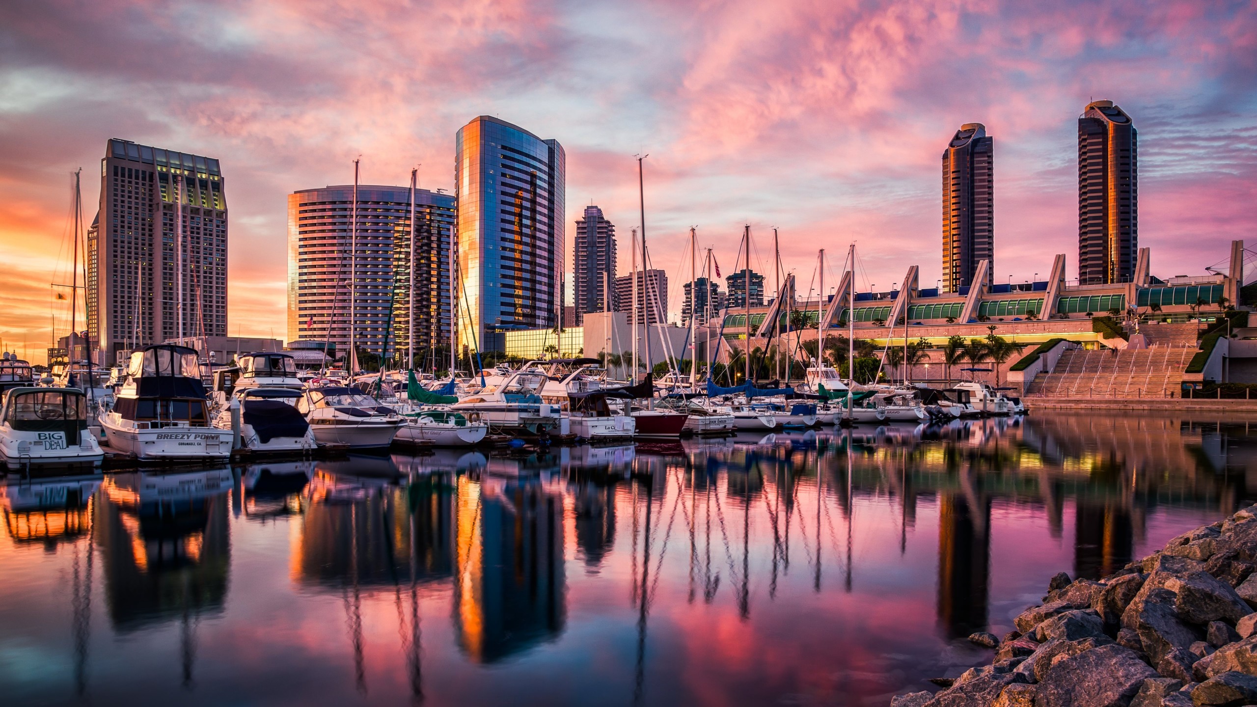 A city skyline with boats in the water - Sunrise