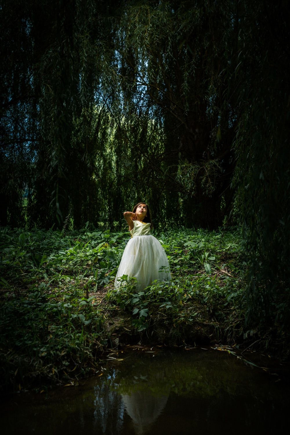 Girl in white dress standing in the middle of the forest - Magic