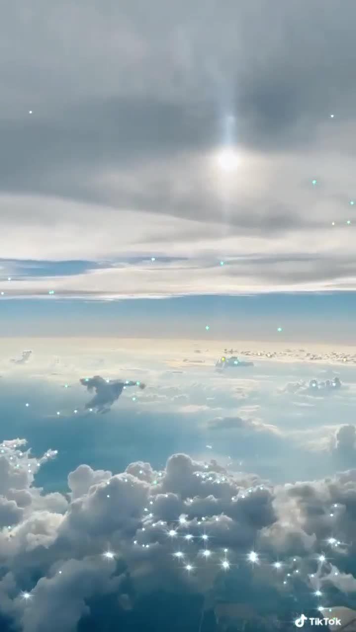 A sky view from above the clouds with a star like light in the distance - Magic