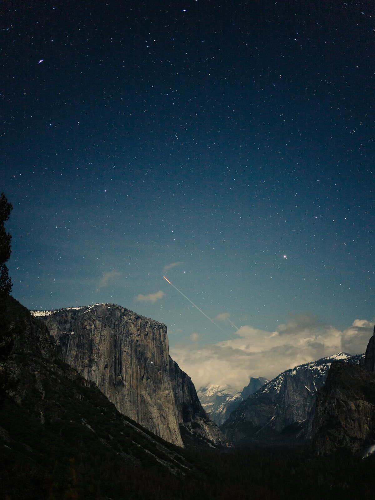 Yosemite National Park at night with a shooting star in the sky. - Magic