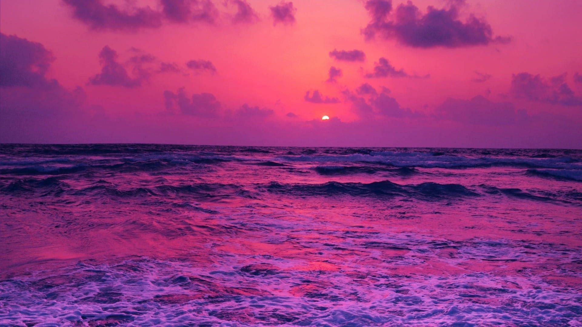 A sunset over the ocean with waves and clouds - Magenta