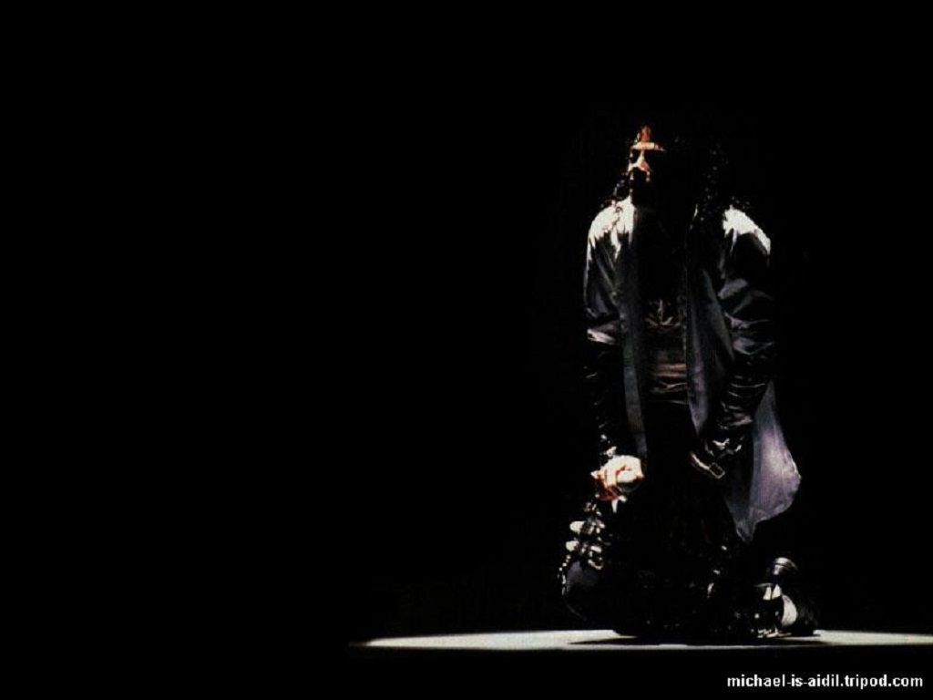 A man in black with his hands on the ground - Michael Jackson