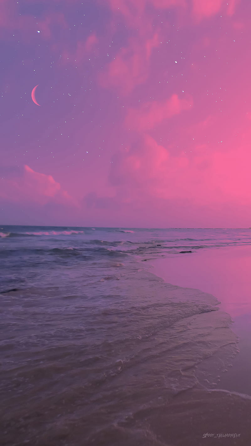 A pink sky with stars and a crescent moon over a beach - Summer