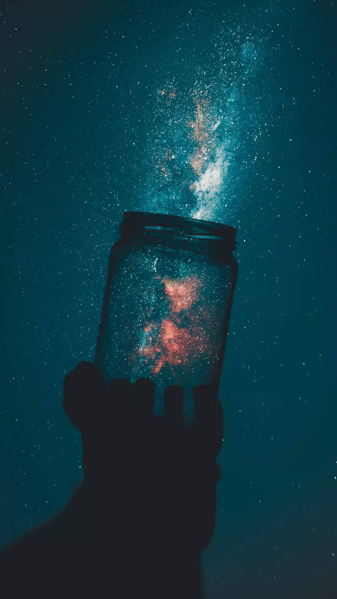 A hand holding up an empty jar with stars in the background - Teal