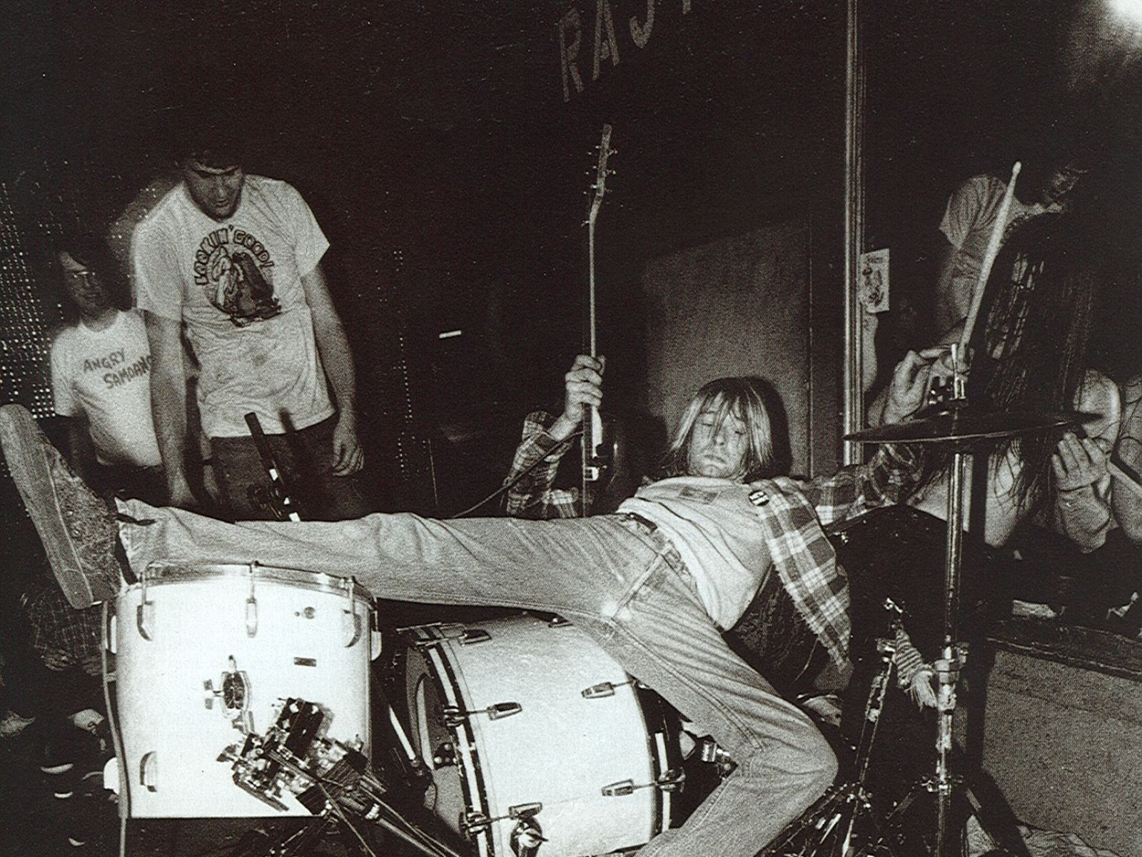 Kurt Cobain of Nirvana sits on a drum set in a scene from the 1995 documentary film 'Hype!' - Nirvana