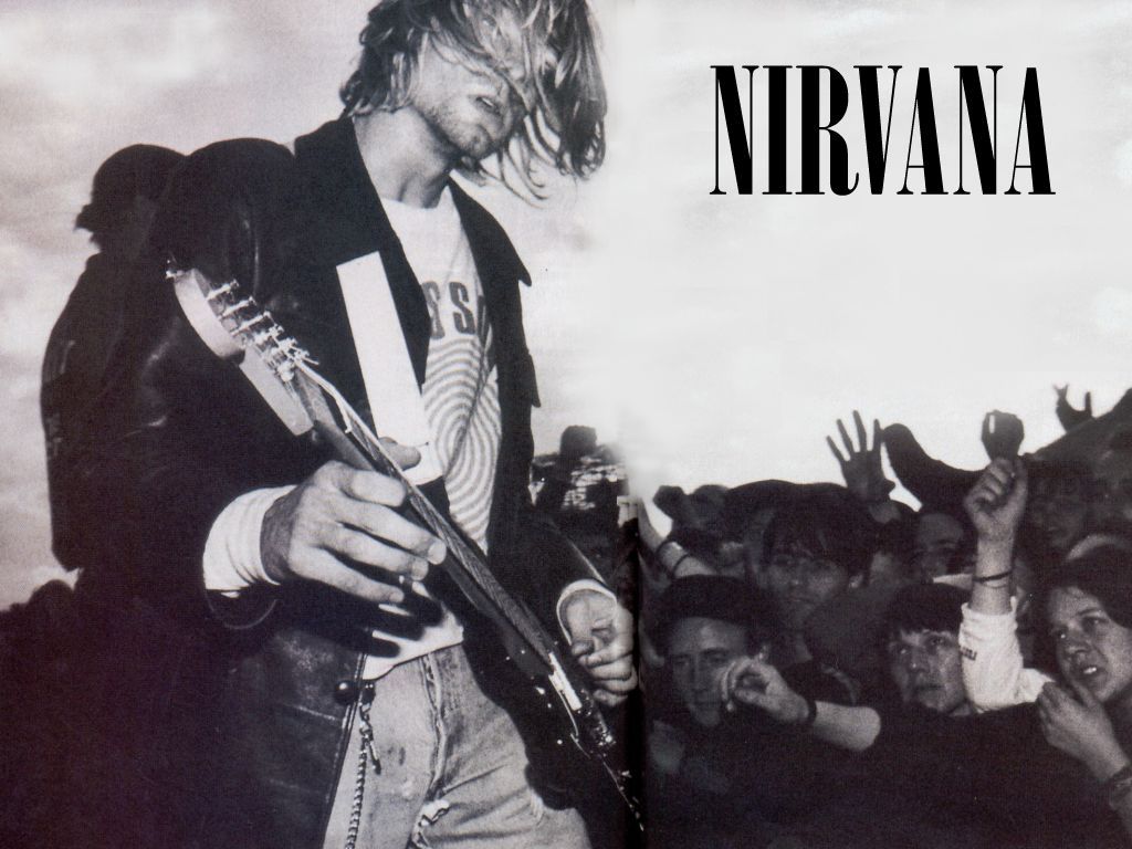 A poster of nirvana with the lead singer playing guitar - Nirvana