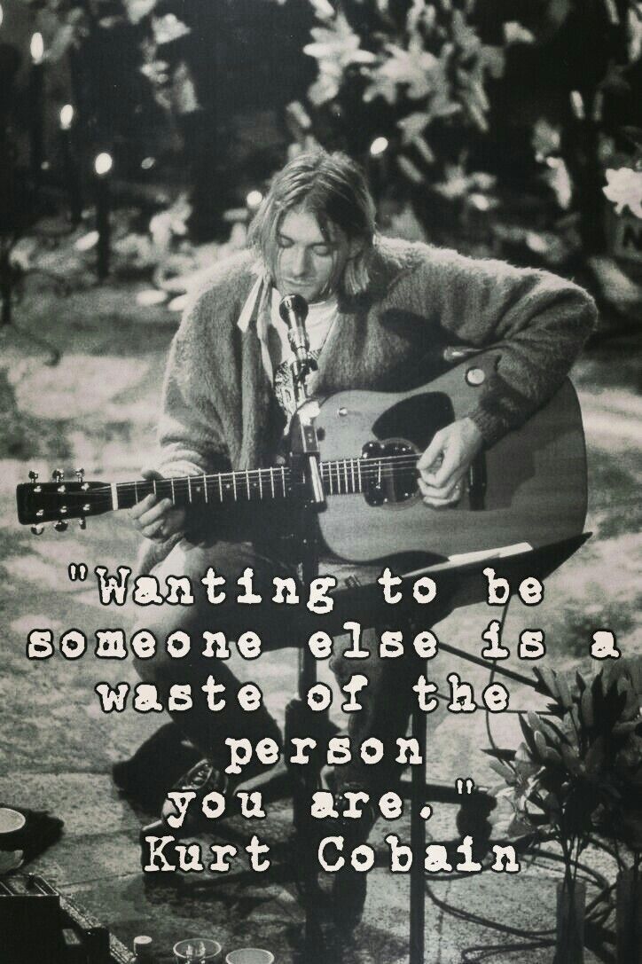 A black and white photo of Kurt Cobain playing a guitar with a quote from him. - Nirvana