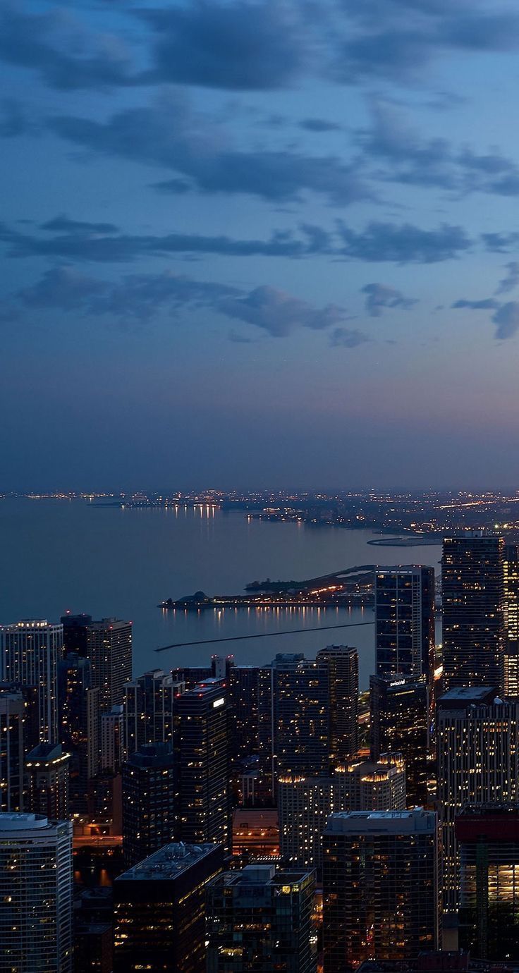 Night cityscape of Chicago with lit up buildings and the lake - City