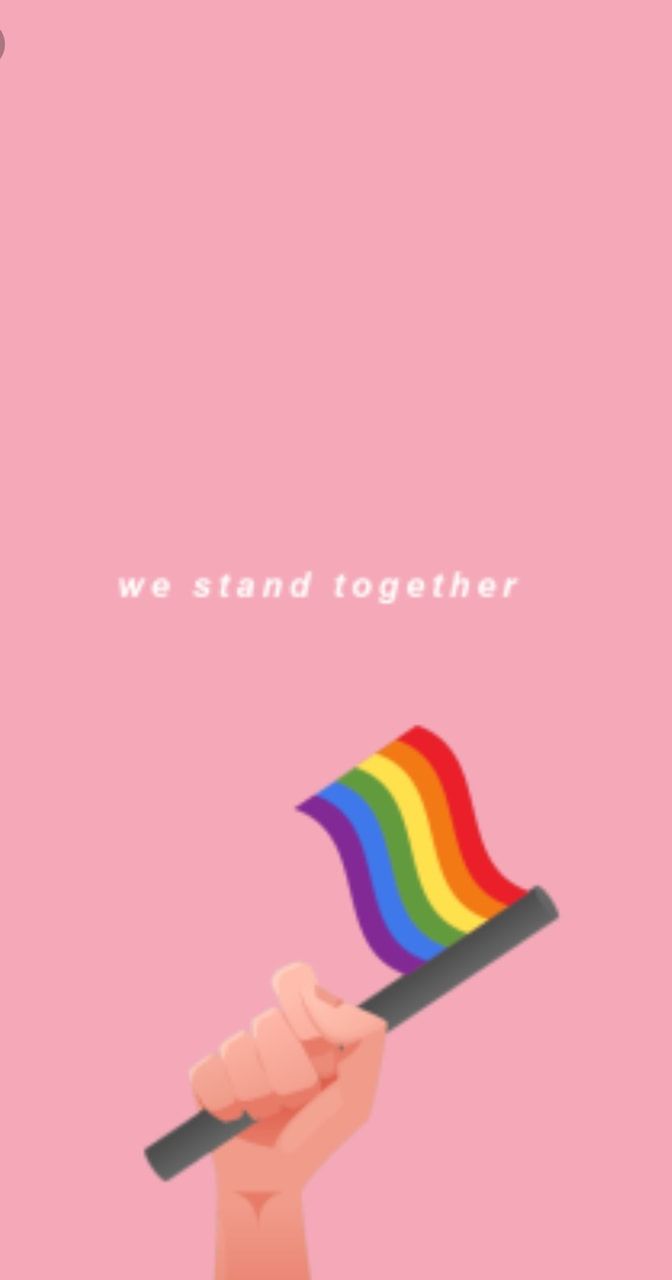 A hand holding a pride flag on a pink background with the words 